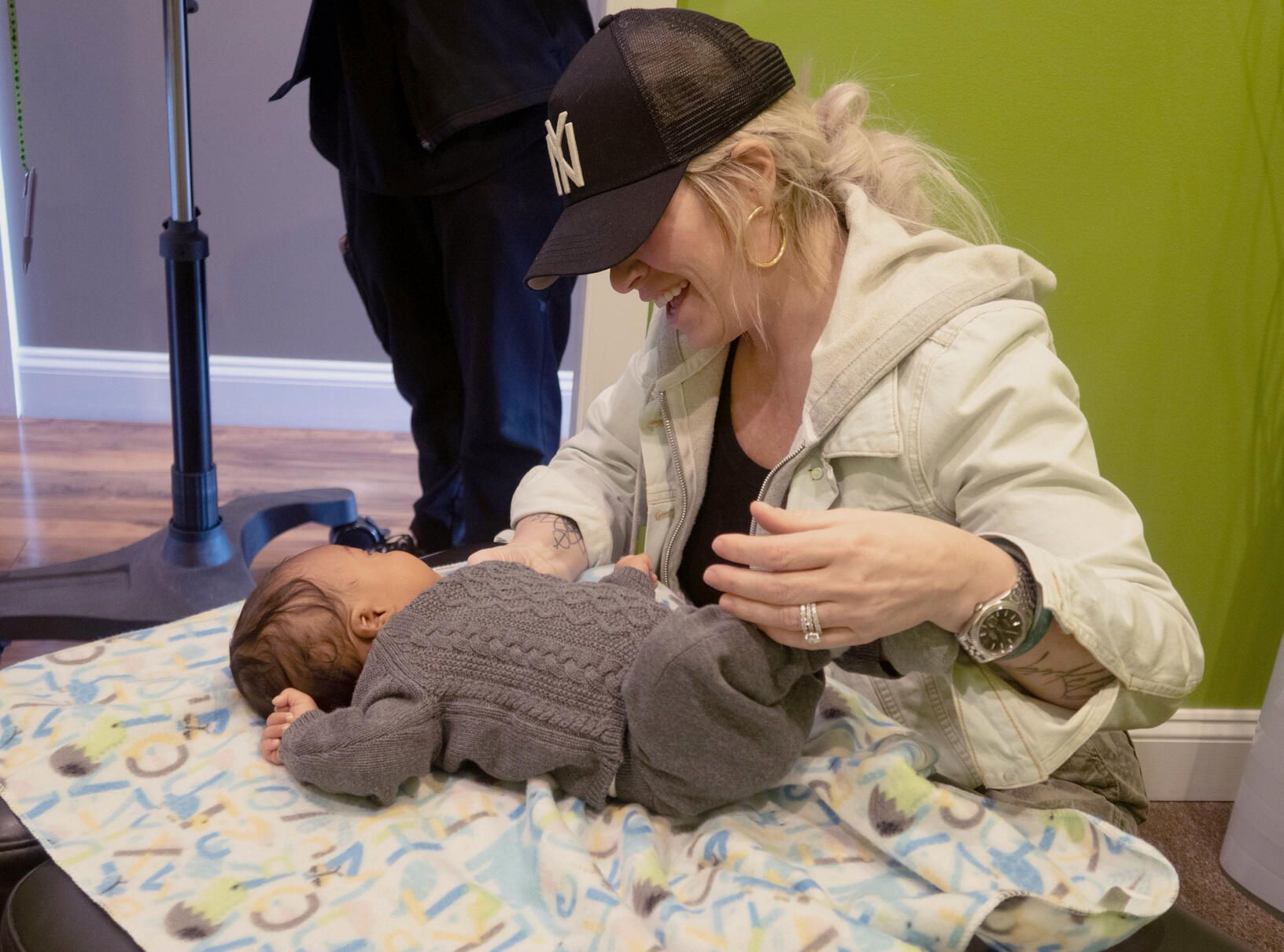 A mom smiling over her baby during an adjustment