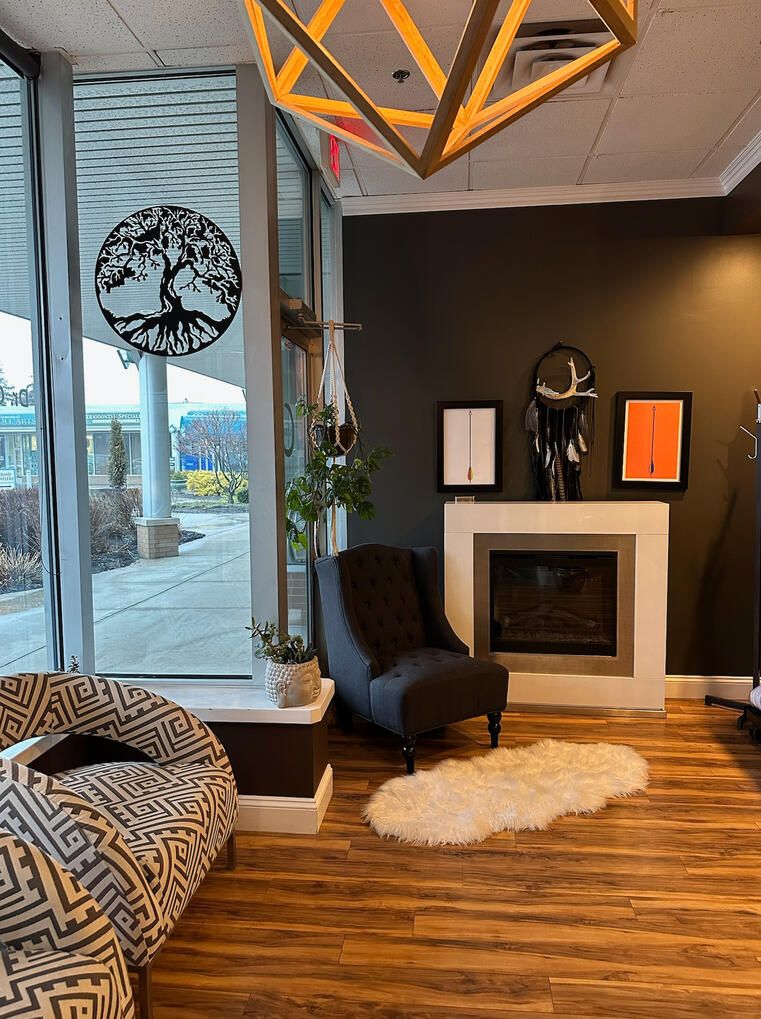 The lobby fireplace corner: wingback chair, fur rug, and a geometric wood pendant light